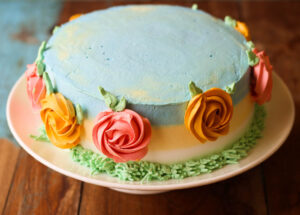 Side view of a whole eggless mango spring cake