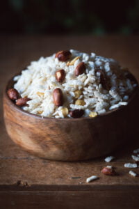 A bowl of freshly prepared Poha Chivda Namkeen garnished with curry leaves and peanuts