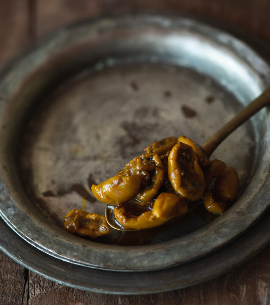 A jar of Karonde Ka Achar, filled with vibrant karonda pickles and spices