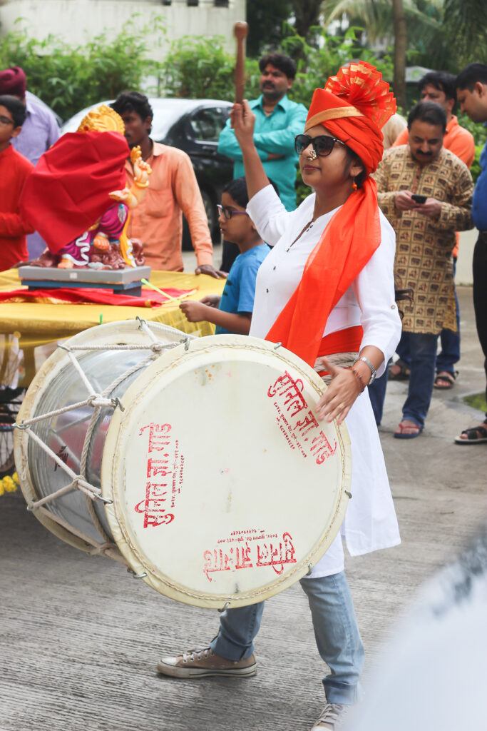 Me with a pair of dhol sticks and joined our society’s pathak