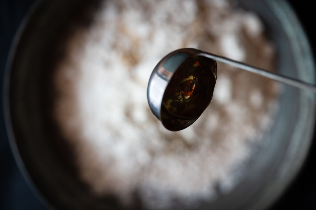 Adding oil to the wheat flour to make soft poori