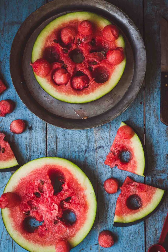 Watermelon kept on the  wooden table and plate